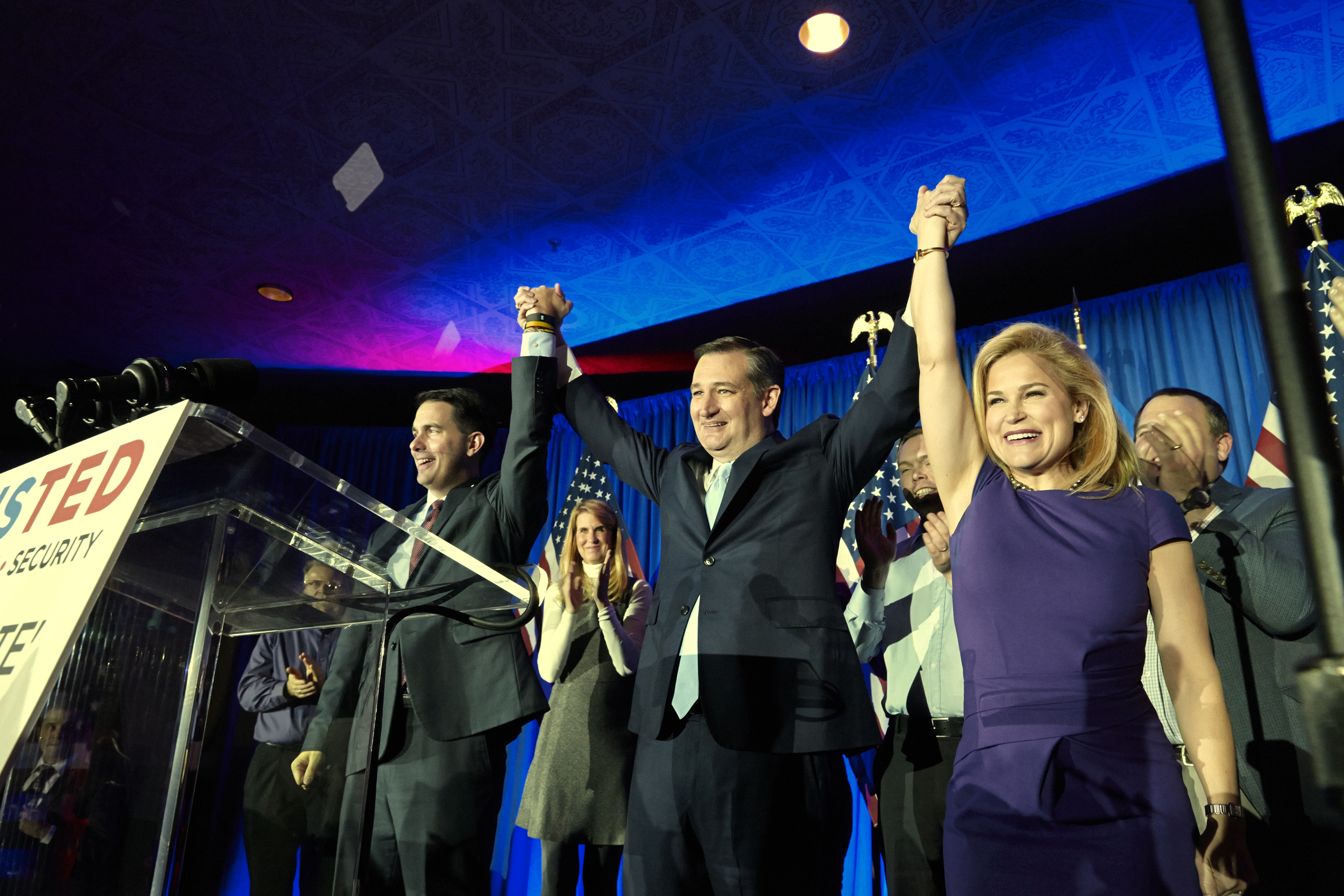 Senator Ted Cruz celebrates winning the Wisconsin primary with his wife Heidi and Governor Scott Walker in Milwaukee on April 5