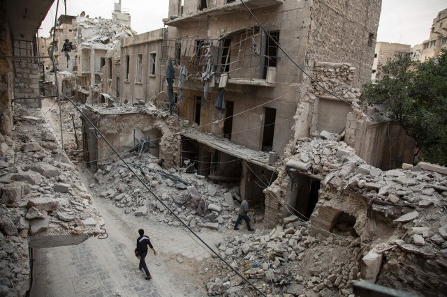 A man walks past destroyed buildings in the Bab al-Hadid neighborhood of Aleppo, Syria, on May 2, 2016. Residents had ventured out onto the streets, taking advantage of a lull in violence in the northern Syrian city as the United States pushed to salvage a ceasefire.