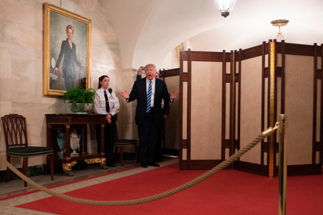 US President Donald Trump surprises visitors during the official reopening of public tours at the White House on March 7, 2017.