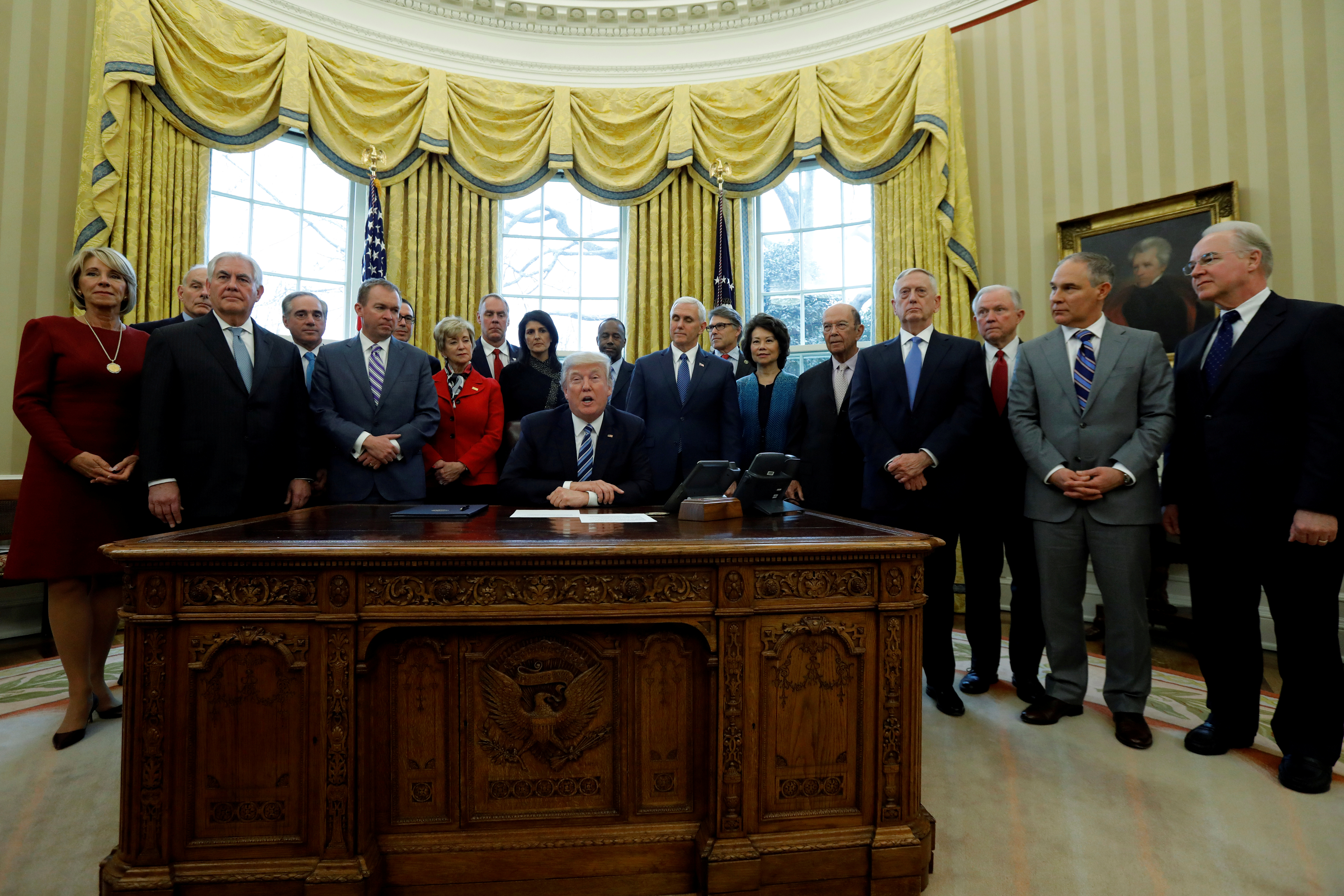 Trump signs an executive order in the Oval Office at the White House in Washington