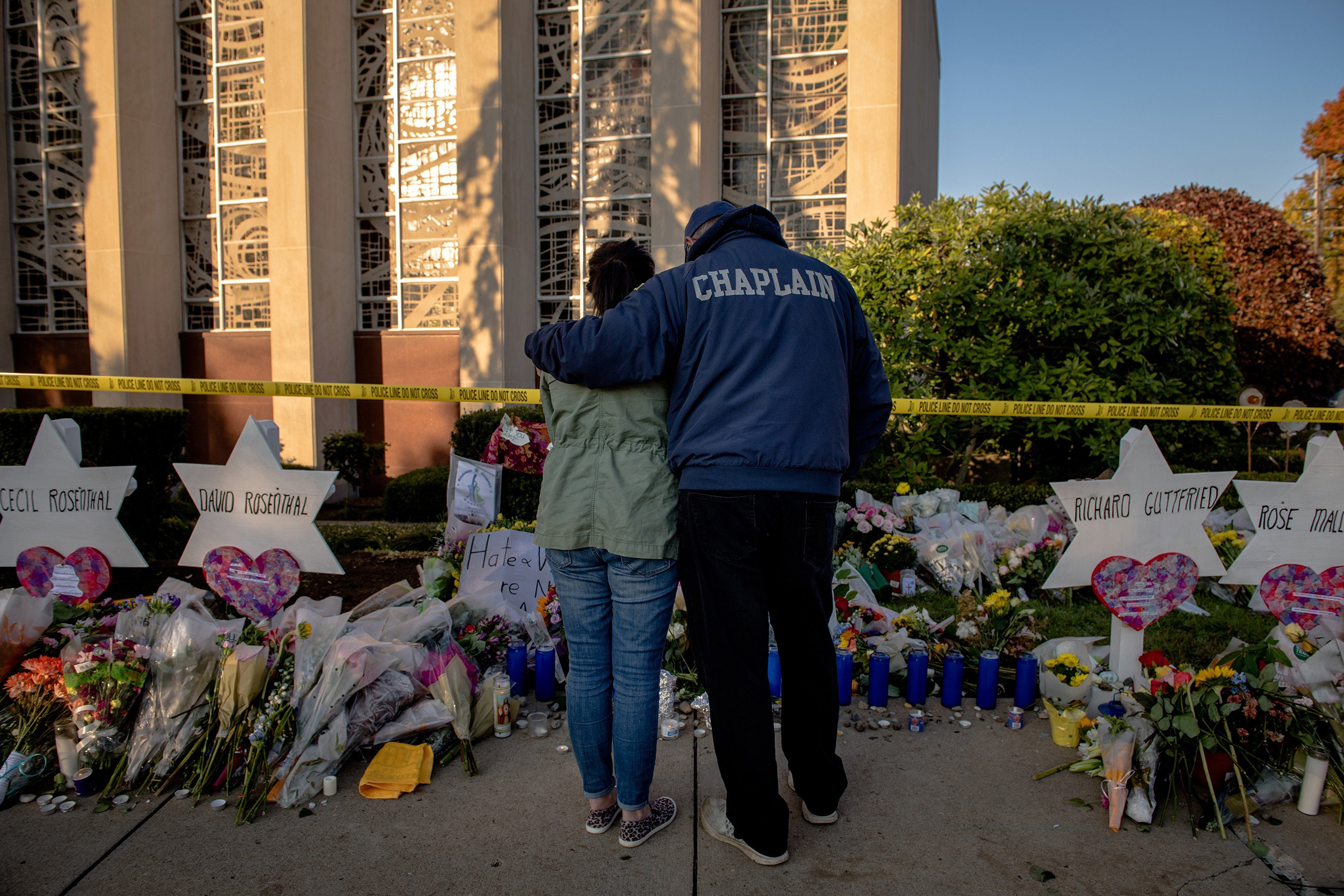 Bob Ossler, a fire department chaplain from Cape Coral, Fla., comforts Melissa Kirchner outside the Tree of Life synagogue on Oct. 30