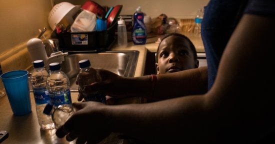 Ariana Hawk, mother of Sincere, now 6, starts warming bottled water to prepare a bath for her two younger children in April 2018.