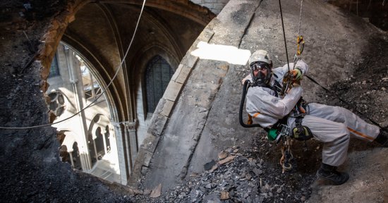 A technician near an open part of the roof on June 25. Some sections of the cathedral have since been exposed to rainfall and high temperatures that France has experienced.