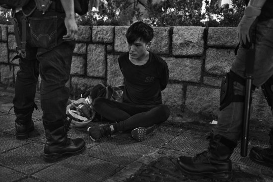 An antigovernment protester is arrested near the Tsim Sha Tsui police station in Kowloon, Hong Kong, on Aug. 11.