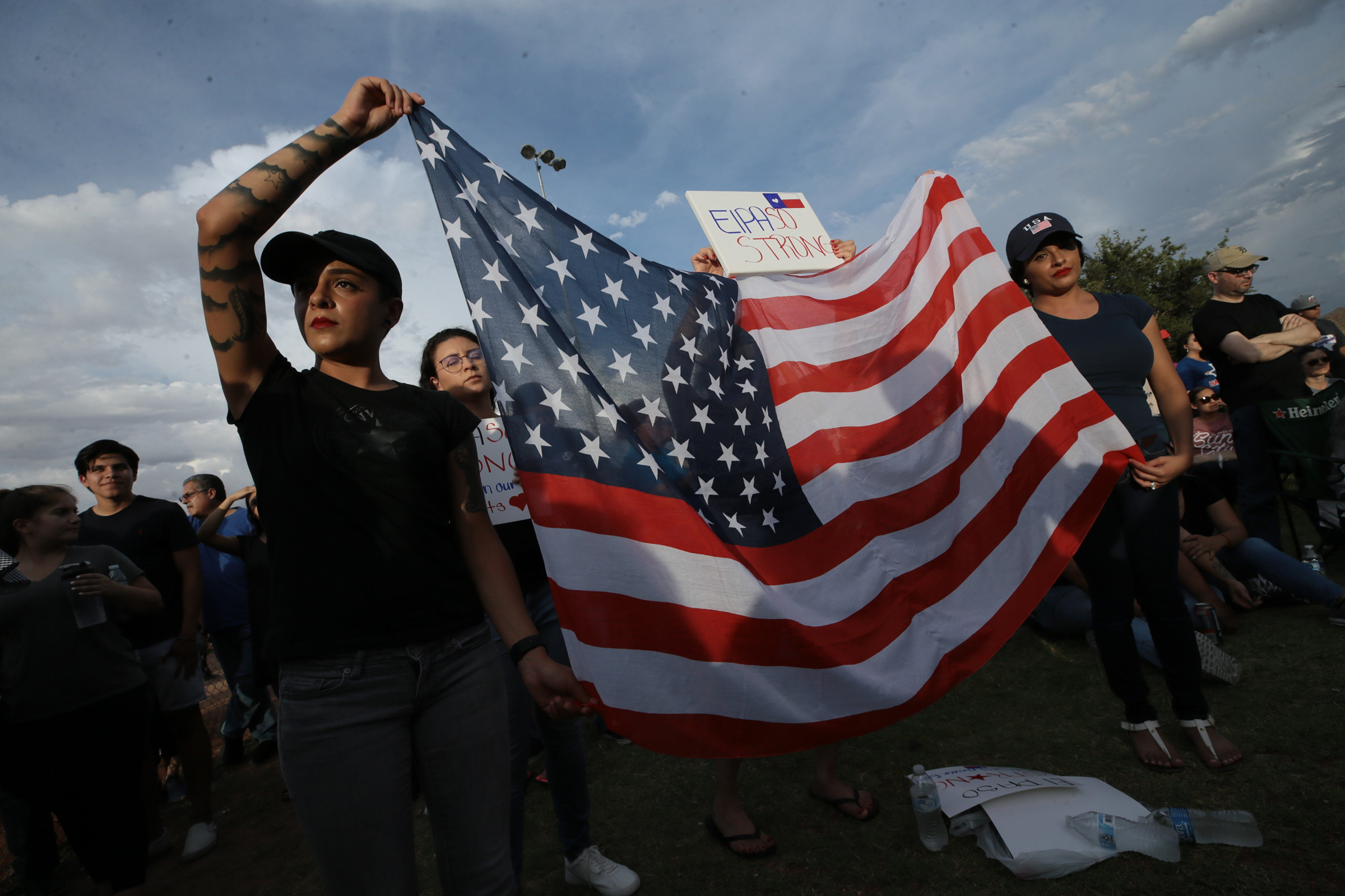 Danielle Novoa, right, with her twin sister Jessica Torres at an interfaith vigil in El Paso’s Ponder Park on Aug. 4.