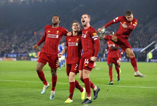 James Milner of Liverpool celebrates with Jordan Henderson and Georginio Wijnaldum during the Premier League match between Leicester City and Liverpool FC at The King Power Stadium in Leicester, United Kingdom on Dec. 26, 2019.