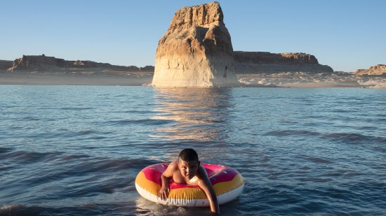 Keethan Tsosie, 9, swims off Lone Rock Beach in Lake Powell while visiting from the Many Farms, Ariz., area of the Navajo Nation on June 12, 2021.