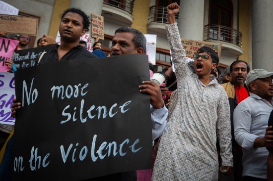 People shout slogans and hold up placards during a protest against violence in the northeastern Indian state of Manipur on July 21 in Bengaluru, India.