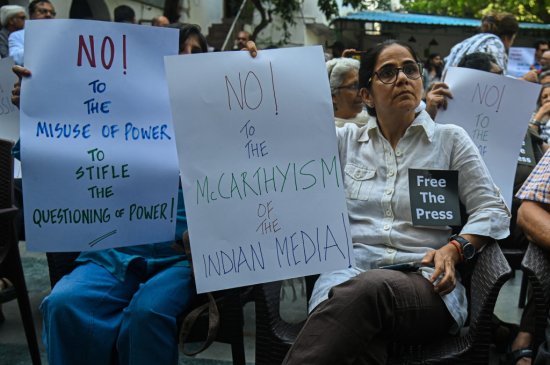 India Members of the media hold placards in a protest against the raids of homes of journalists and writers belonging a news portal in New Delhi, India on Oct. 04, 2023. Police Raids