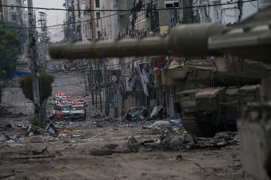 Ambulances are seen on a road near an Israeli forces tank during an Israeli army ground operation in the Gaza Strip on Nov. 22.