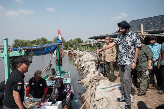 World Bank President Ajay Banga, right, at work in Indonesia