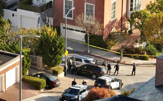 San Francisco police officers and F.B.I. agents gather in front of the home of U.S. Speaker of the House Nancy Pelosi