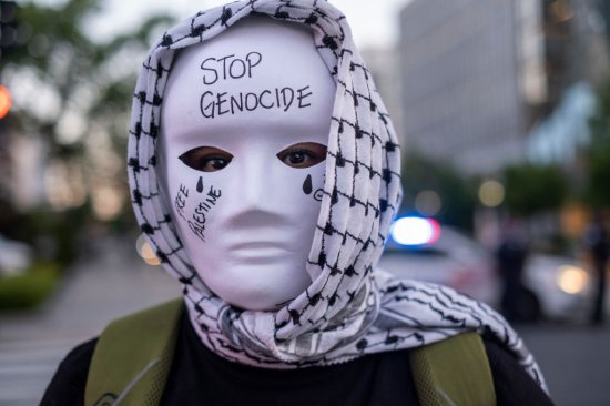 A demonstrator wearing traditional Palestinian Keffiyeh and